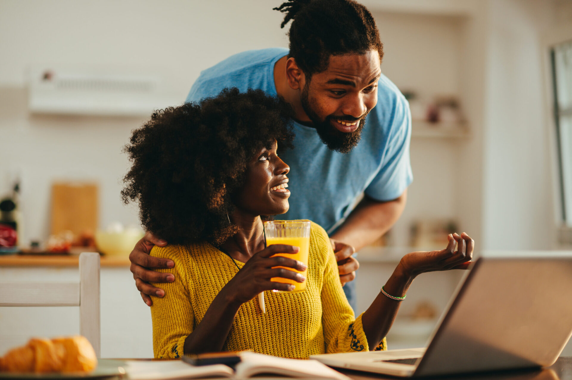 Happy African couple on laptop