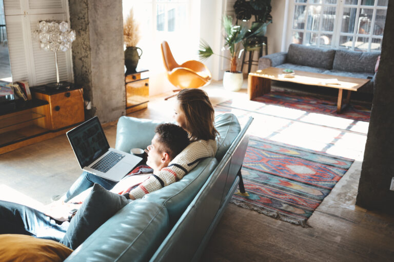 Couple looking for tenant information on a couch