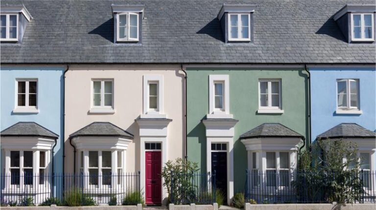Row of colorful UK terraced houses, typical in conveyancing.