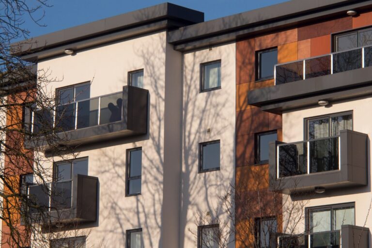 Contemporary apartment building with sleek balconies and clean architecture, ideal for property investors seeking flats for sale in urban or suburban areas.