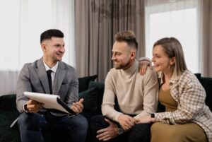 Estate agent meeting with a couple in a modern living room, representing landlord support ahead of new Renters’ Rights Act compliance changes.
