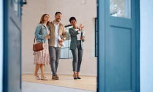A couple viewing a rental property with an estate agent, representing landlords and tenants preparing for changes under the Renters’ Reform Act in Lichfield.