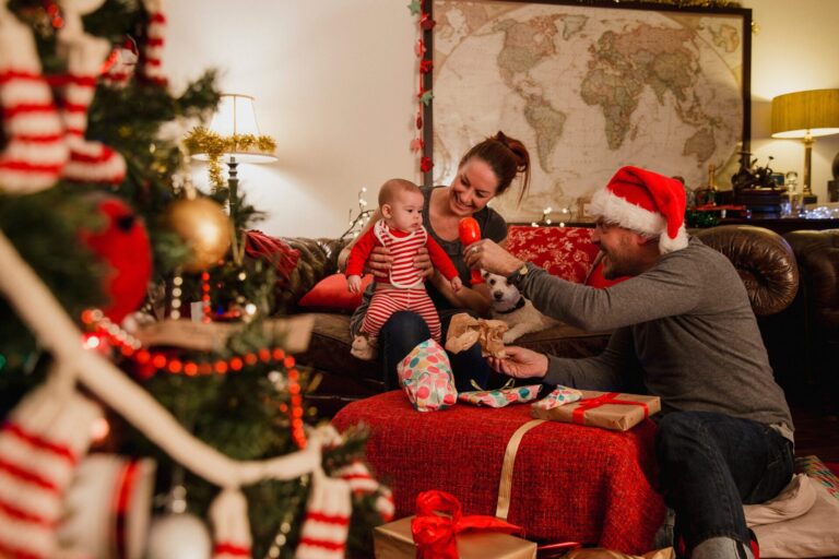 Family celebrating Christmas together at home in Sutton Coldfield, opening presents and enjoying festive decorations in a cosy living room