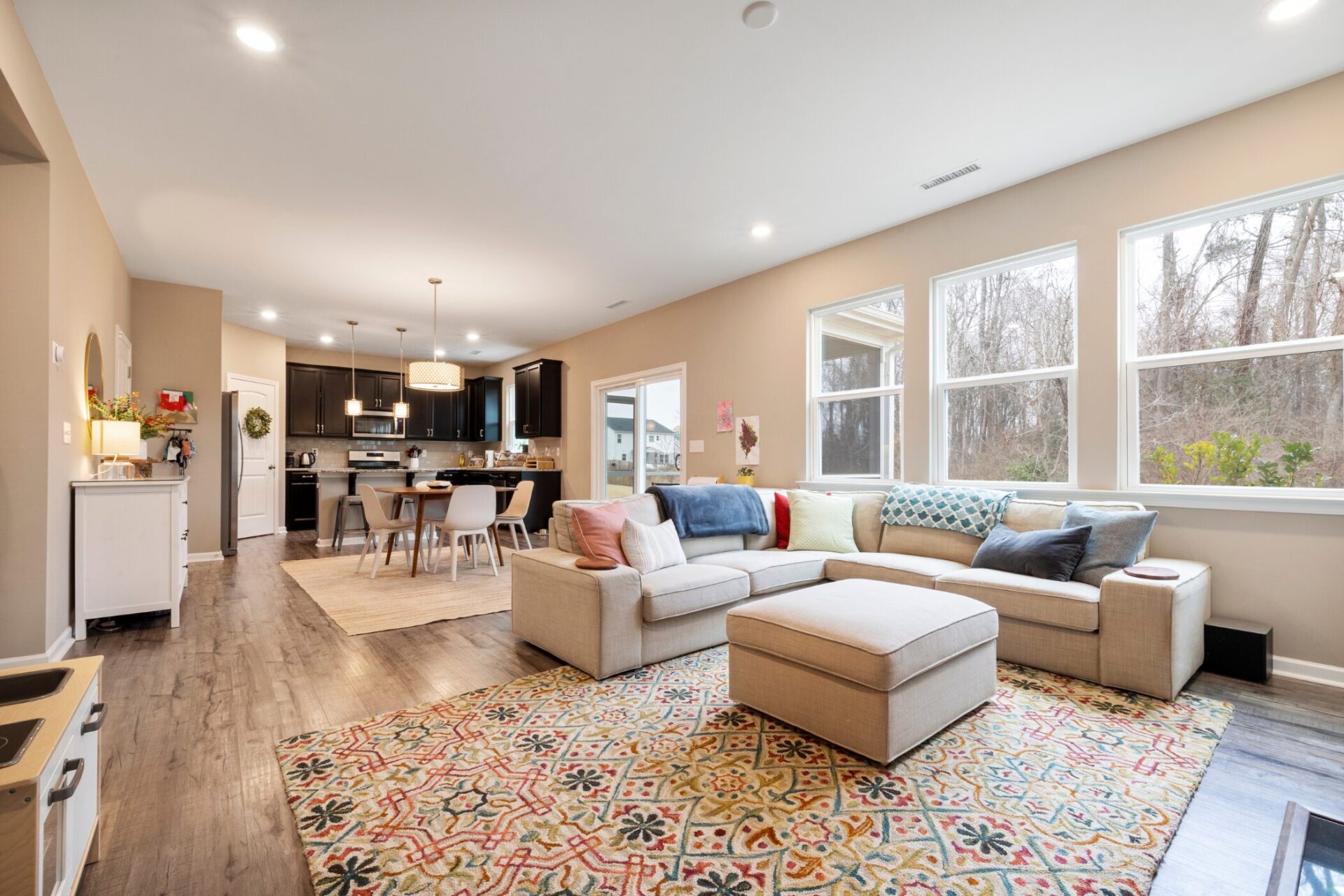 Modern open-plan living room and kitchen in a Stanmore home, showing good ventilation and natural light to help prevent damp and mould in winter