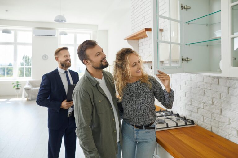 Couple viewing a home in Cheltenham with an estate agent during winter