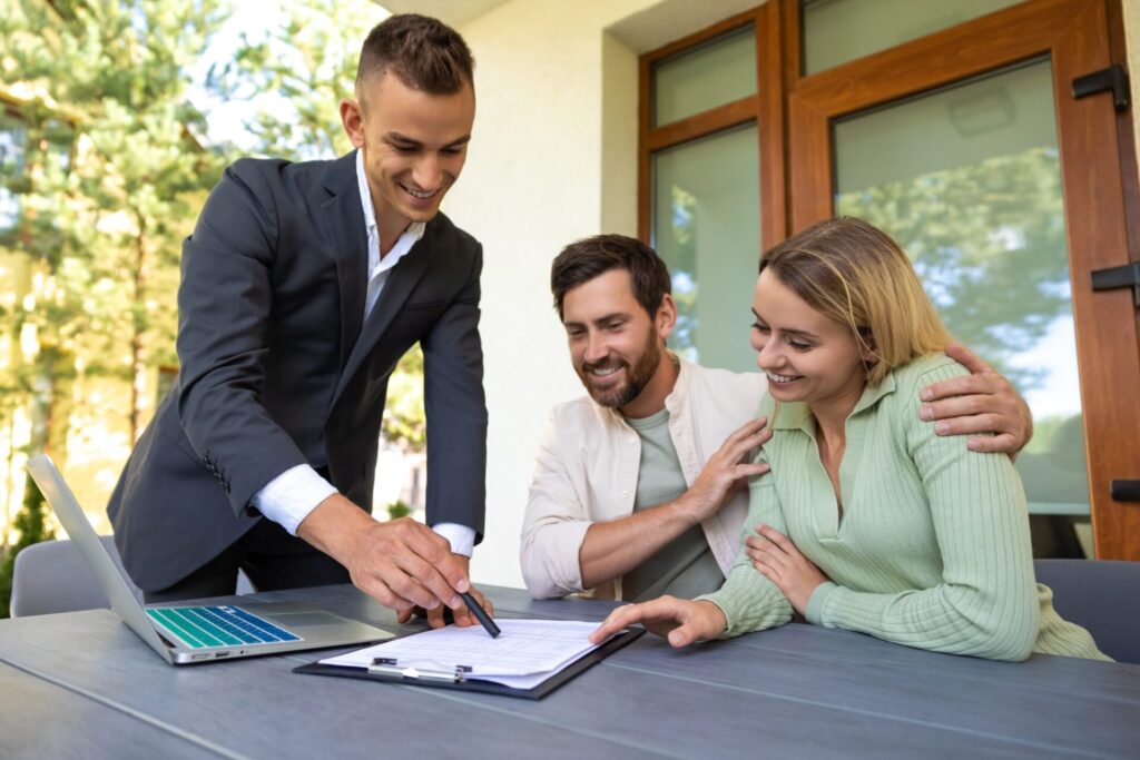 Estate agent discussing a house sale with homeowners in Chesterfield following the Aurora rail launch