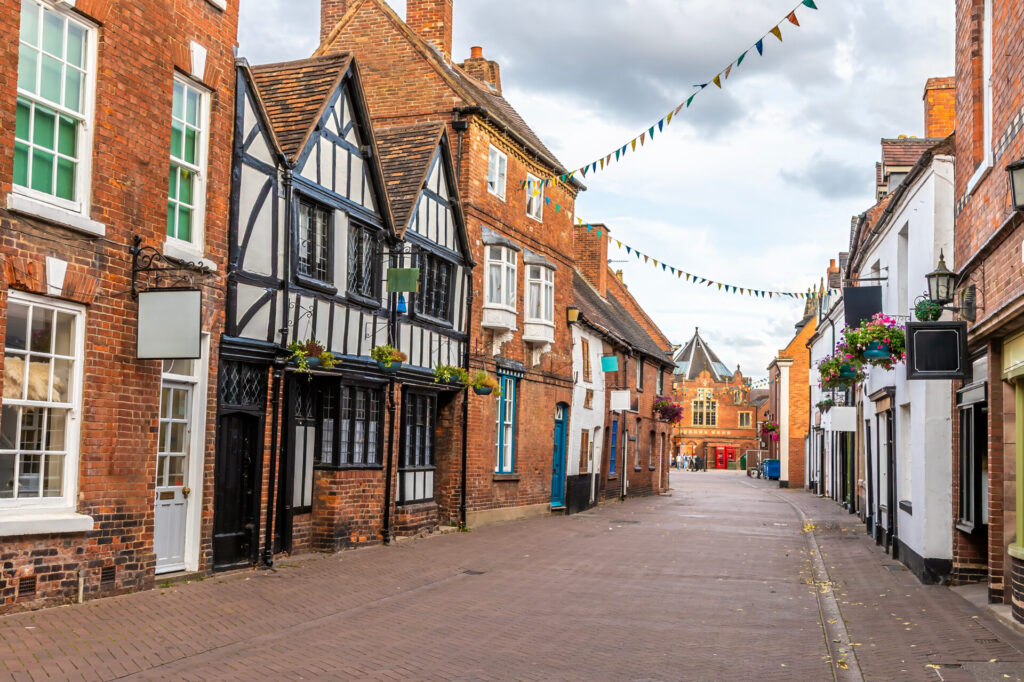 Traditional red brick buildings lining a historic street in Lichfield city centre, close to the new Everyman Cinema development