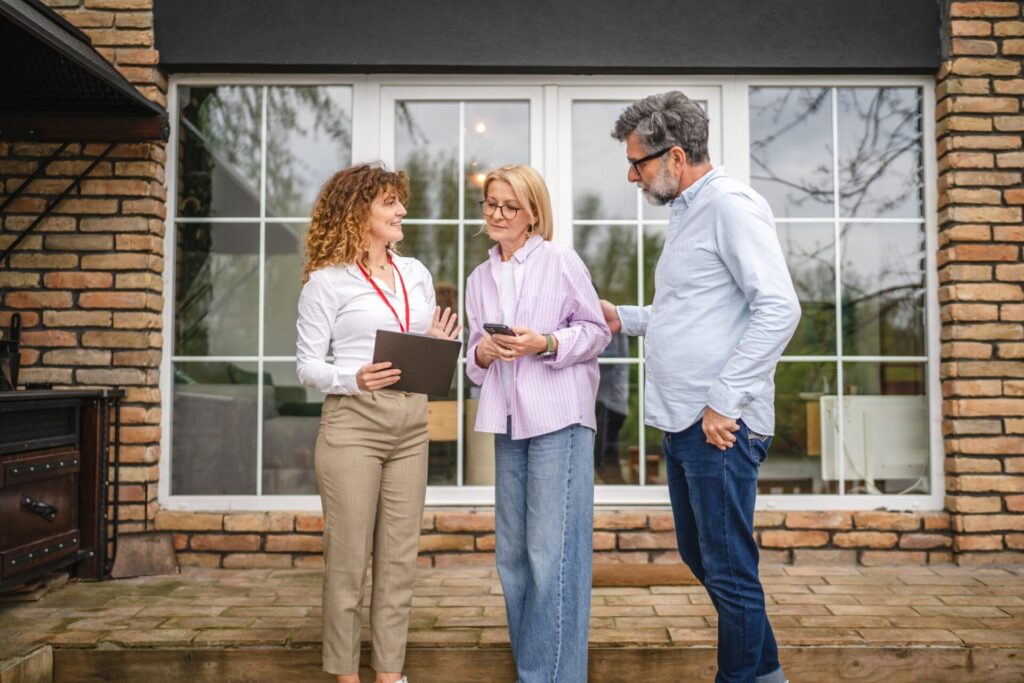 Estate agent speaking with homeowners outside a Maesteg property as part of local regeneration discussions