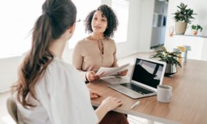 Property adviser discussing investment documents with a client during a consultation in Cheltenham