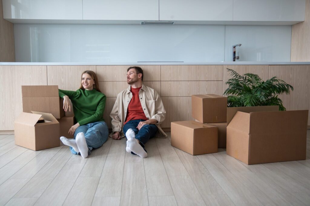 Tenants sitting among moving boxes in a modern Harborne rental property during a house move
