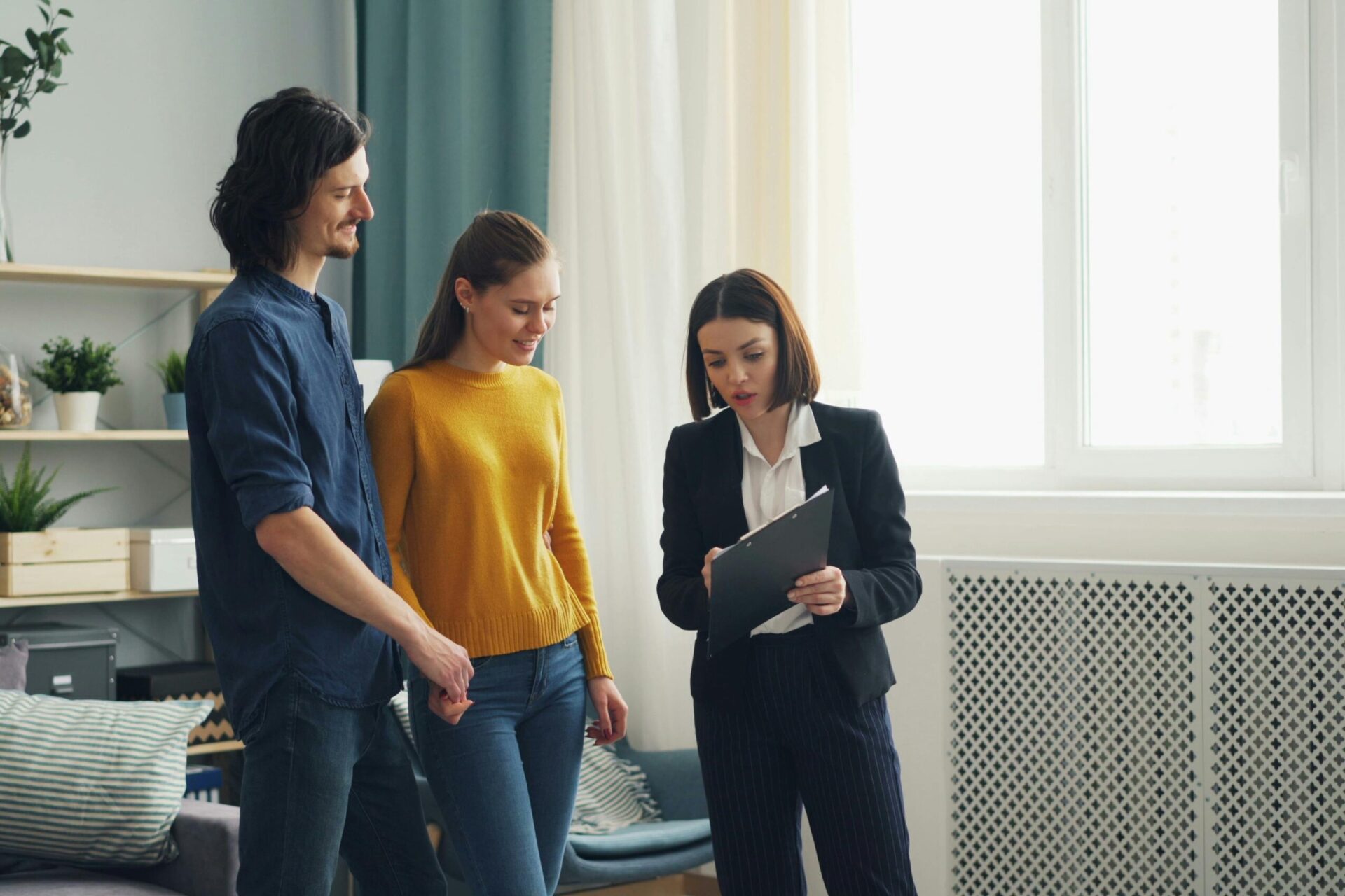 Letting agent discussing rental legislation and tenancy changes with landlords inside a property