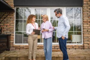 Lettings agent discussing a rental property with professional tenants outside a modern home, reflecting York’s growing professional lettings market in 2026