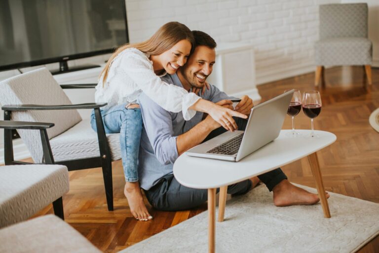 Couple sitting at home discussing rental management and finances with a laptop in a Camberwell property