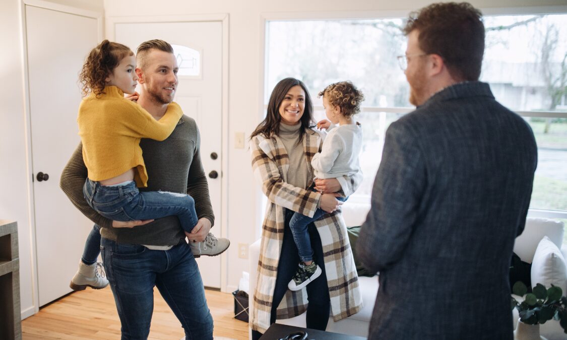 Lettings agent discussing a rental property with a family during a Gravesend home viewing