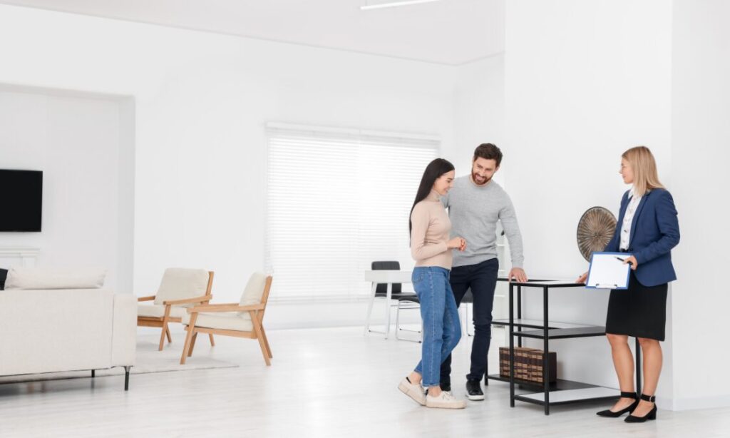 Estate agent advising a couple in a modern home, representing Solihull HS2 property investment and professional rental demand near Arden Cross.