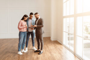 Letting agent showing a bright two-bedroom property to two professional tenants in Harborne in 2026