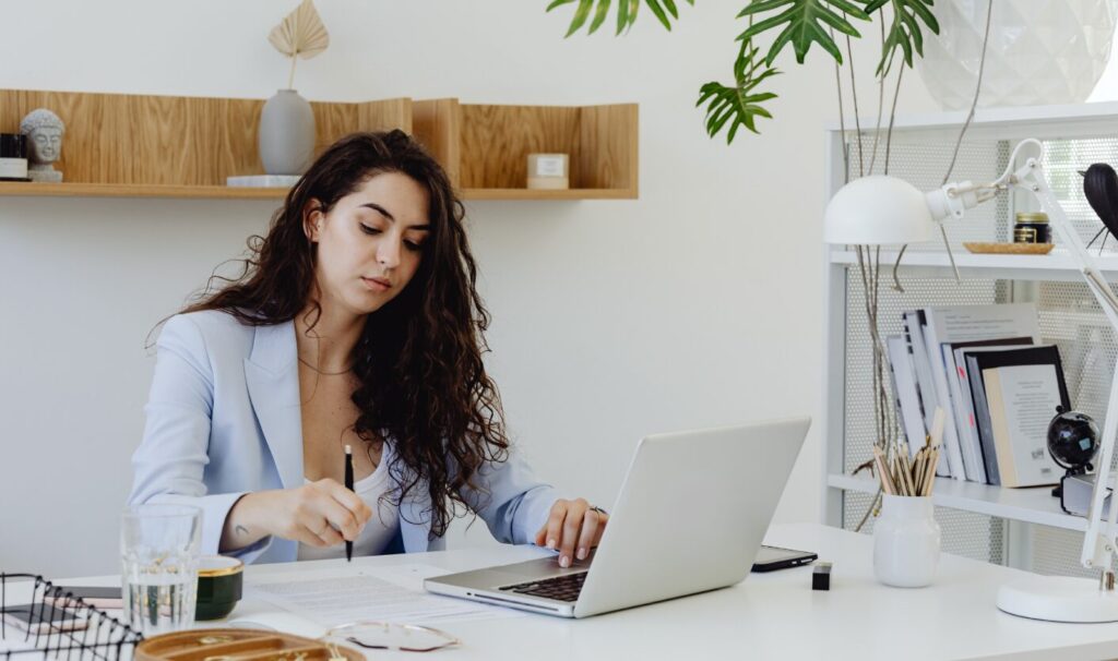 Landlord working at a desk updating rental income records digitally for Making Tax Digital compliance