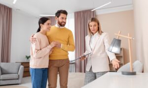 Letting agent explaining Property Portal compliance requirements to landlords in a modern rental property