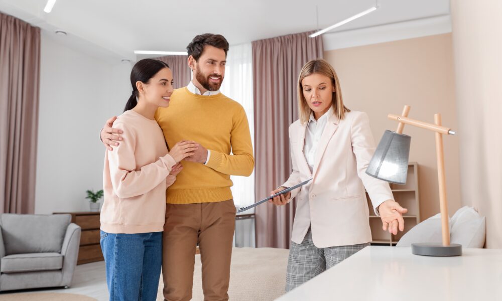 Letting agent explaining Property Portal compliance requirements to landlords in a modern rental property