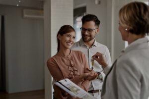 Estate agent handing keys to tenants in a Salford Quays apartment, reflecting strong Manchester buy-to-let demand in 2026