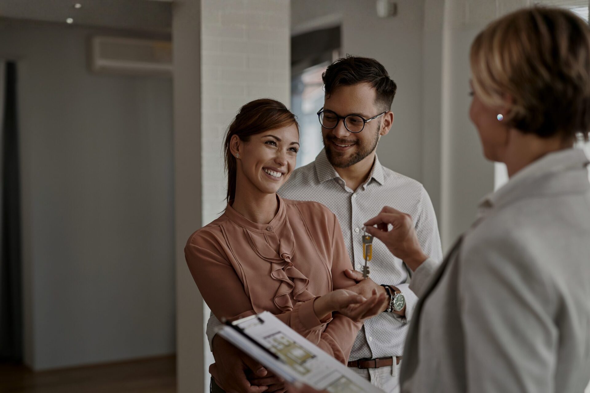 Estate agent handing keys to tenants in a Salford Quays apartment, reflecting strong Manchester buy-to-let demand in 2026