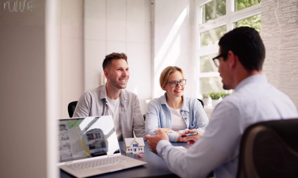 Home sellers meeting with an estate agent to discuss a property sale and faster conveyancing in Bridgend