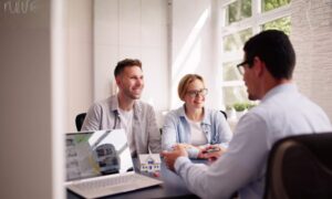 Home sellers meeting with an estate agent to discuss a property sale and faster conveyancing in Bridgend