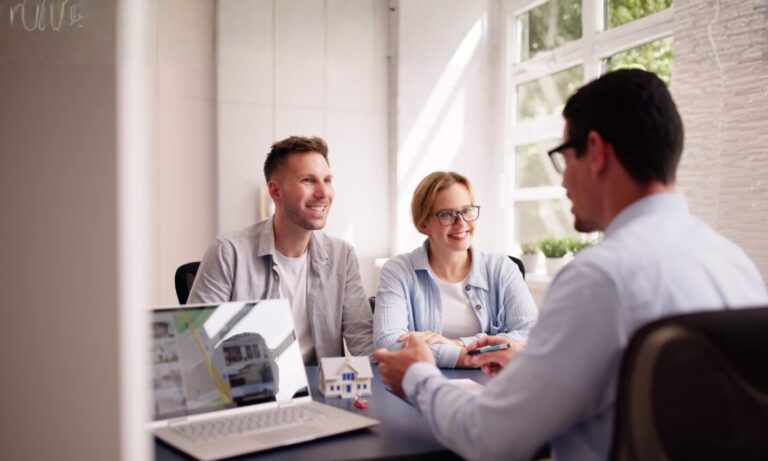 Home sellers meeting with an estate agent to discuss a property sale and faster conveyancing in Bridgend
