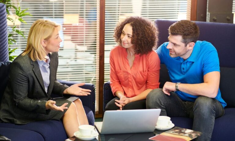 Estate agent speaking with a couple about downsizing and releasing equity from their Lichfield home in 2026