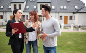 Letting agent speaking with landlords outside a modern residential property, highlighting the benefits of full property management in Bishopsworth in 2026