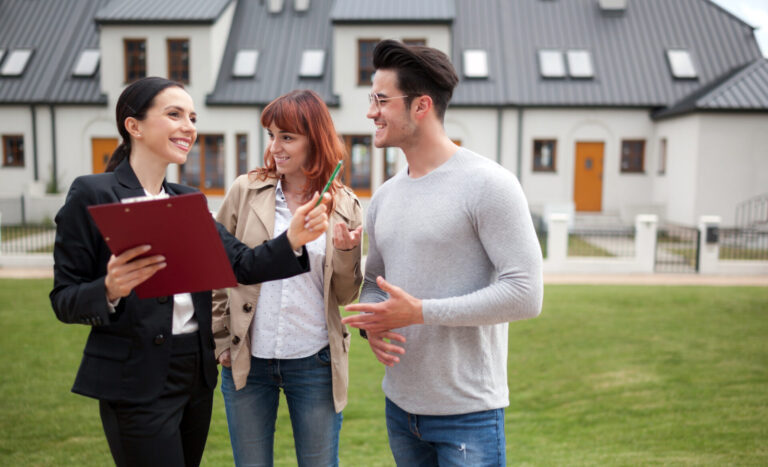 Letting agent speaking with landlords outside a modern residential property, highlighting the benefits of full property management in Bishopsworth in 2026