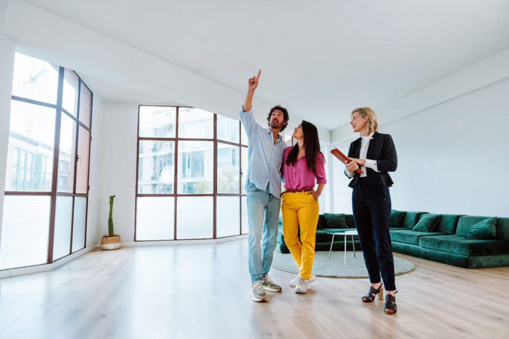 Estate agent conducting a property viewing in a bright Regency-style Cheltenham home, highlighting staging for a premium 2026 sale