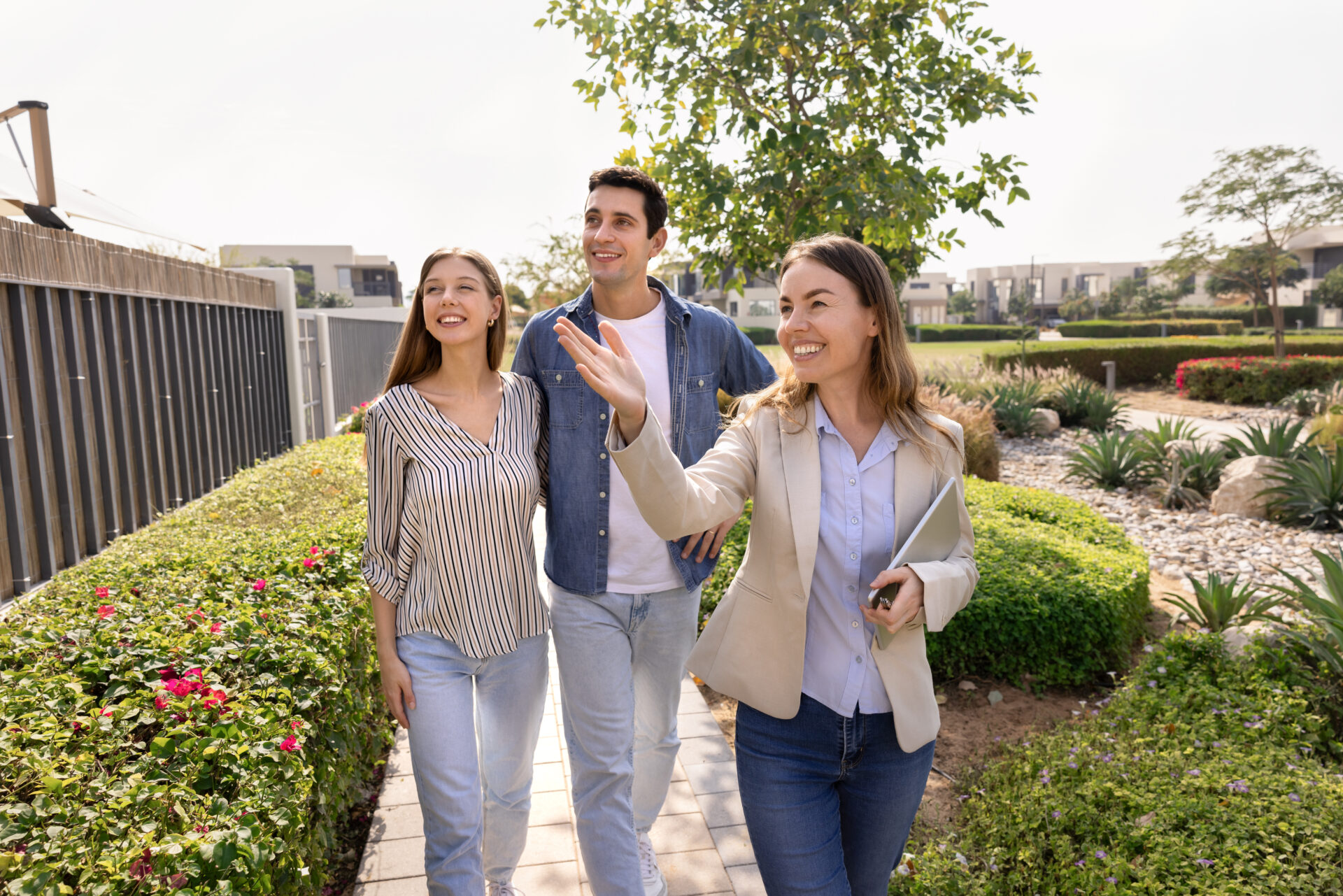 Estate agent showing a modern home to a professional couple near Staveley, reflecting rising demand from East Midlands Investment Zone workers