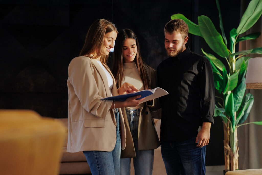 Estate agent reviewing rental documents with tenants, representing landlord compliance and the Renters’ Rights Act changes for Stanmore landlords.