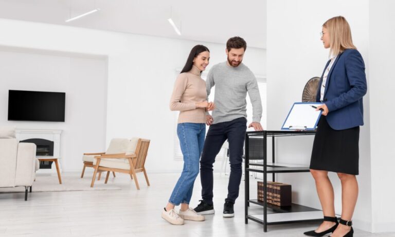 Estate agent discussing property details with a couple during a viewing, reflecting buy-to-let investment opportunities in Knowle.