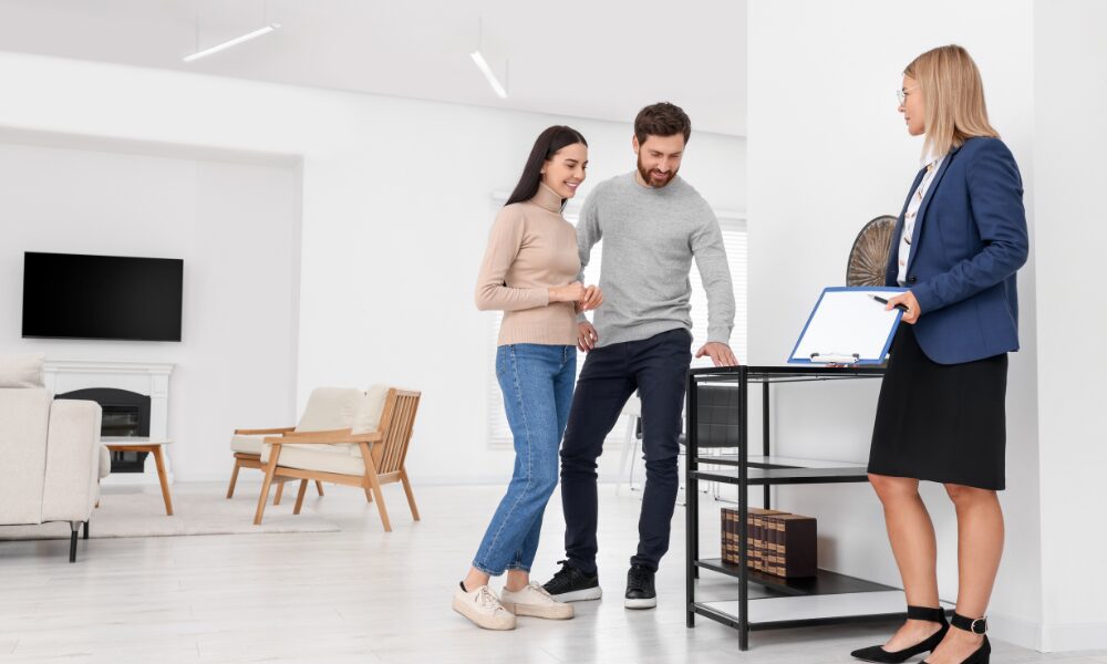 Estate agent discussing property details with a couple during a viewing, reflecting buy-to-let investment opportunities in Knowle.