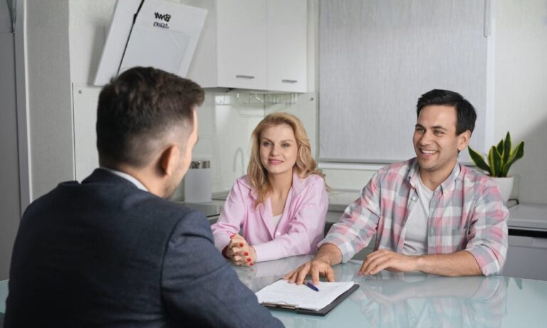 Couple discussing property investment with an estate agent, representing buy-to-let opportunities and rental yield hotspots in Skipton.
