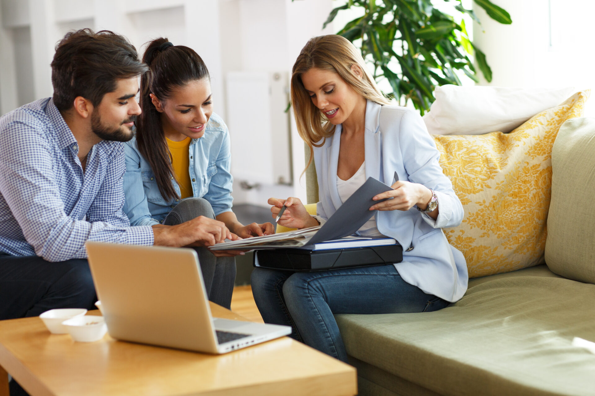 Estate agent reviewing property investment documents with a couple, representing buy-to-let opportunities and rental growth in Tamworth.