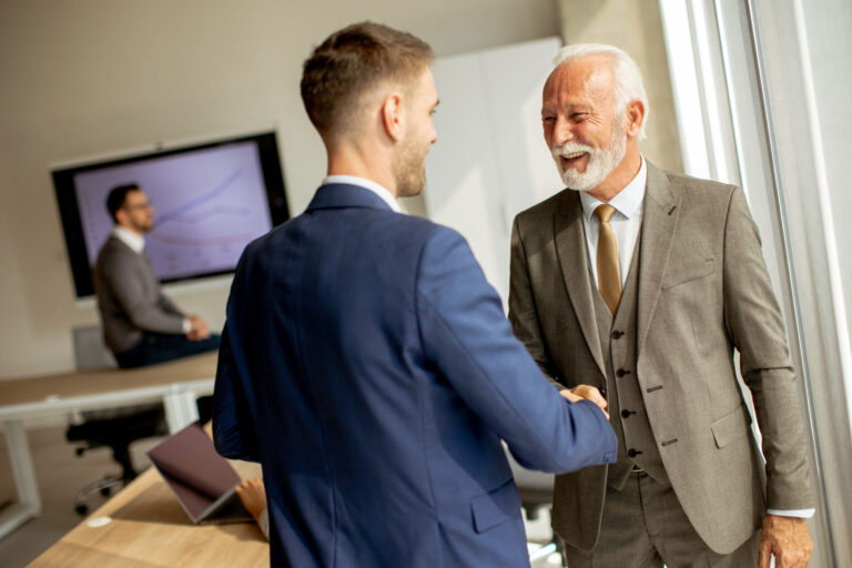 Landlord and letting agent shaking hands during tenancy agreement meeting