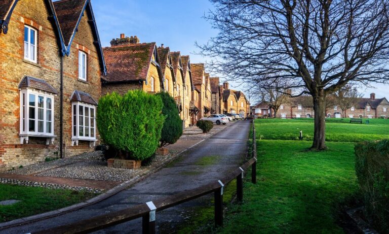 Row of traditional houses beside a green park in a quiet residential area