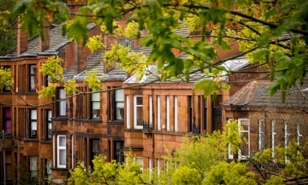 Row of traditional residential houses in Dumfries surrounded by greenery
