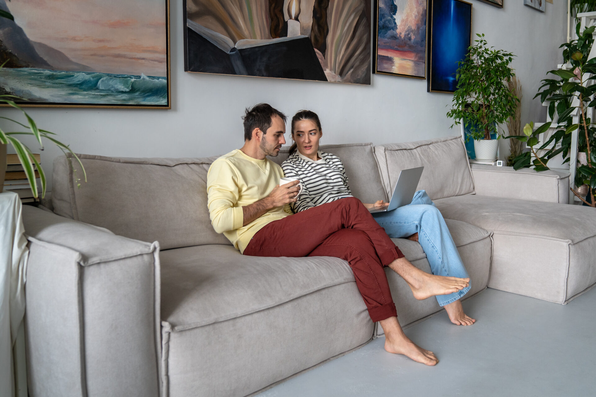 Couple sitting at home using a laptop to research property in Knowle near HS2 interchange