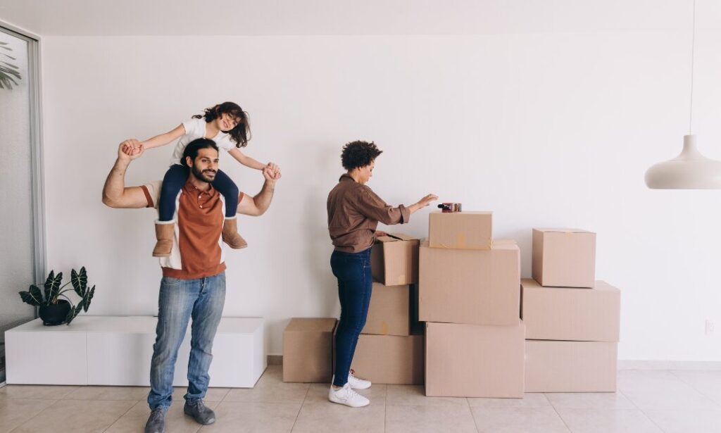 Family unpacking boxes after moving into new home in Bierley Bradford