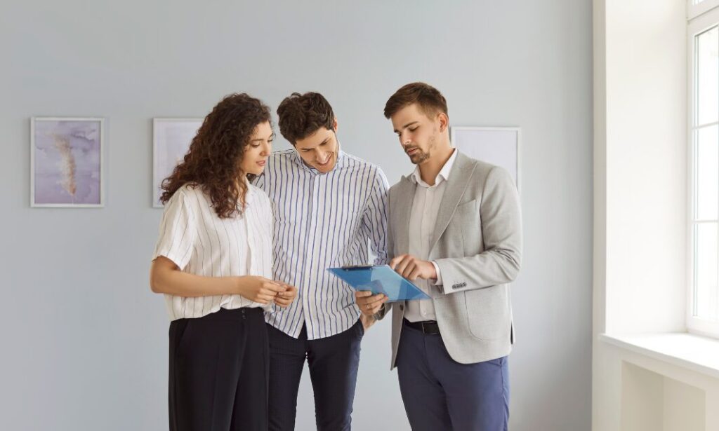 Estate agent reviewing property details with couple in Monkspath Solihull