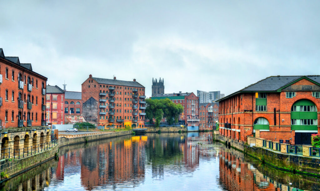 Waterfront buildings and apartments along a river in Leeds city