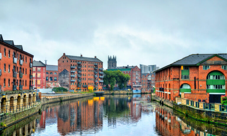 Waterfront buildings and apartments along a river in Leeds city