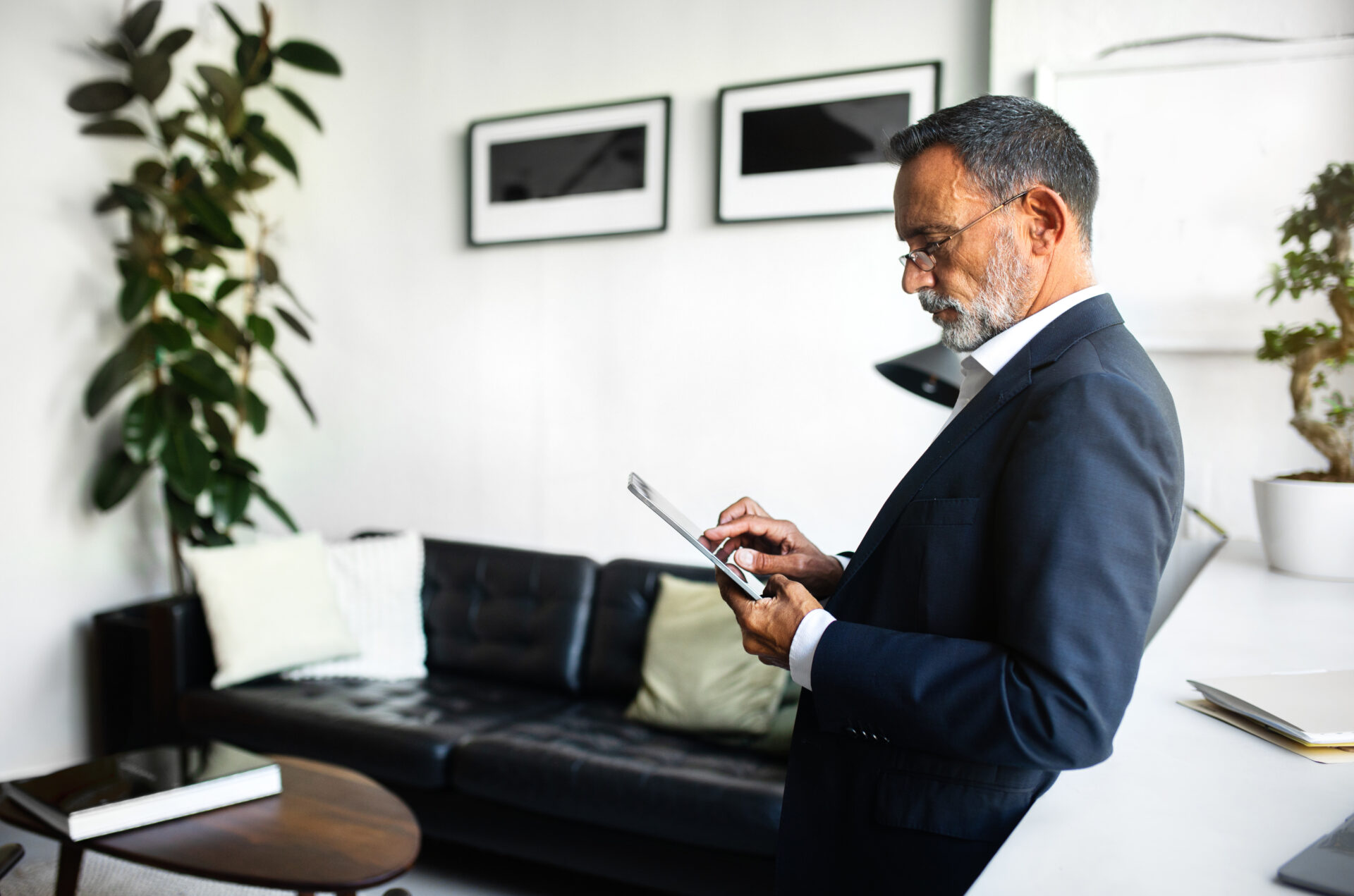 landlord reviewing property investment details on tablet inside modern rental property
