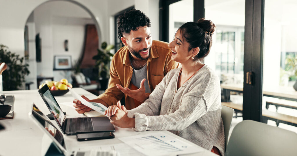 couple reviewing property documents with estate agent advice in modern home setting