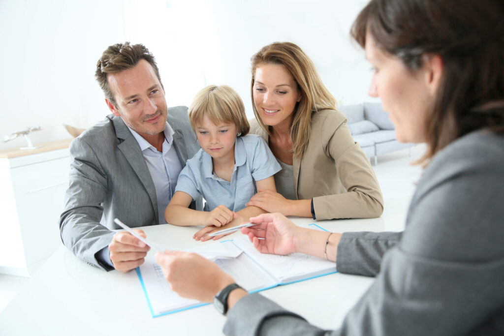 family discussing rental property options with agent in modern office setting
