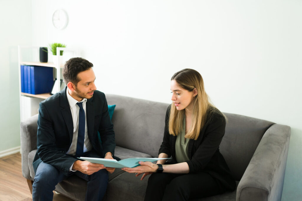 estate agent showing property details on tablet to prospective renter in modern apartment